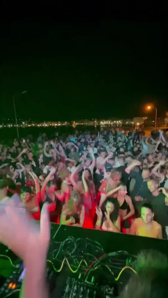 Play clip: the dance floor from the DJ booth, hands in the air.