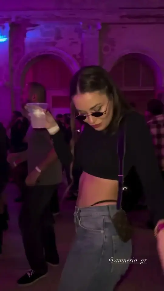 Play clip: dancing in an old hall washed in purple light.